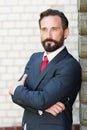 Calm man leaning against the wall and looking thoughtful Royalty Free Stock Photo