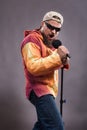 Bearded emotional rock singer with microphone studio portrait.