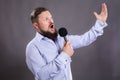 Bearded emotional singer with micriphone dressed in shirt Royalty Free Stock Photo