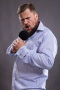 Bearded emotional singer with micriphone dressed in shirt Royalty Free Stock Photo