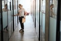 Bearded employee in glasses opens the door