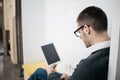 Bearded employee working on tablet at office