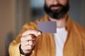 Bearded entrepreneur giving hand empty black business card on blurred background. Mockup Copy Paste Blank Advertisement. Royalty Free Stock Photo