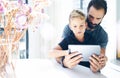 Bearded father with his young son using tablet PC in sunny room.Dad and little boy playing together on mobile computer, resting in Royalty Free Stock Photo