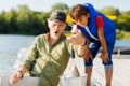 Bearded grandfather showing his boy big fish