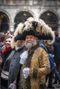 Bearded gray-haired senior man in a big carnival tricorn hat and medieval costume at the carnival in Venice
