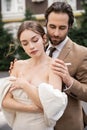 bearded groom in formal wear hugging Royalty Free Stock Photo