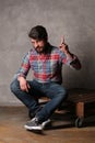 Bearded guy in colorful shirt shows finger up Royalty Free Stock Photo