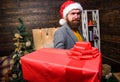 Bearded guy with eyeglasses carry present box. Delivery christmas present. Delivery service. Christmas is coming. Santa