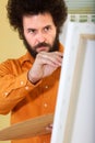 Bearded guy painting a picture in his studio Royalty Free Stock Photo