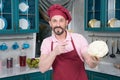 Bearded guy pointing on Cauliflower in hand. Smiling chef holds white big cauliflower in hand