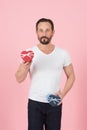 Bearded guy with red and blue hearts in hands. I prepared gift for you. Young man in white t-shirt holding gift boxes Royalty Free Stock Photo