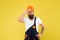 Bearded guy worker on yellow background. Home Design and Renovation Trends. Engineer builder uniform. Man builder hard Royalty Free Stock Photo