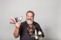 bearded hairdresser for dogs with combs and a terrier on his hands