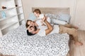 Handsome man raising his baby over his head while his wife looking at them Royalty Free Stock Photo