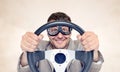 Bearded happy man in stylish goggles with steering wheel on background, car driver concept Royalty Free Stock Photo