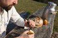 Bearded hermit eating cheese and bread in the nature Royalty Free Stock Photo