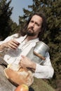 Bearded hermit eating cheese and bread in the nature Royalty Free Stock Photo