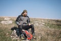 Bearded hiker with hiking equipment resting on a stone Royalty Free Stock Photo