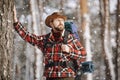 Bearded Hiker Leaning on Winter Forest Tree