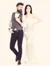 Bearded hipster with bride dressed up for wedding ceremony. Wedding concept. Woman in wedding dress and man in vest