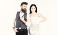 Bearded hipster with bride dressed up for wedding ceremony. Woman in wedding dress and man in vest. Couple in love