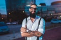 Hipster businessman standing outdoor in office building background