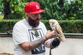 Bearded hipster with an owl in his hand