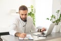 Bearded hipster style adult man working writing, freelance home sitting male typing on keyboard