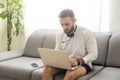 Bearded hipster style adult man working writing, freelance home sitting male typing on keyboard