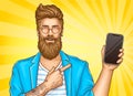 Bearded hipster with tattoos point on smartphone