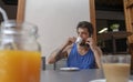 Bearded hispanic boy meeting friends in a terrace drinking coffee and busy listening and planing by his cellphone in short shirt