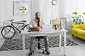 bearded hispanic freelancer sitting at workplace