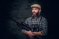 Bearded hunter holds a rifle. Royalty Free Stock Photo