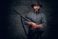 Bearded hunter holds a rifle. Royalty Free Stock Photo