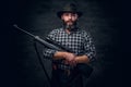 Bearded hunter holds a rifle. Royalty Free Stock Photo