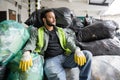 Bearded indian sorter in fluorescent vest