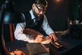 Bearded journalist in glasses writes with feather Royalty Free Stock Photo