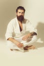 Bearded karate man, brutal caucasian serious hipster in kimono Royalty Free Stock Photo