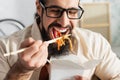 bearded latin man in eyeglasses eating