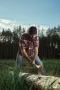 Bearded Lumberjack in a Hat cut a Tree Royalty Free Stock Photo