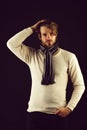 Bearded macho with striped scarf looking confidently