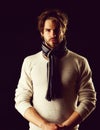 Bearded macho with tied striped scarf looking confidently