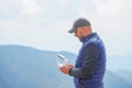 Bearded male model use drone remote control to fly device in air. Man operating drone flying in nature. New technologies