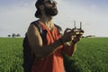 Bearded male model use drone remote control to fly device in air. Man operating drone flying in nature. New technologies Royalty Free Stock Photo