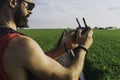 Bearded male model use drone remote control to fly device in air. Man operating drone flying in nature. New technologies Royalty Free Stock Photo