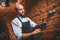 Bearded male working with boots