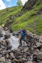 Bearded man adventurer with backpack is preparing to jump over a Royalty Free Stock Photo