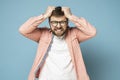 Bearded man in anger and furious, he is trying to tear out his hair on head and grins teeth.