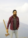 Bearded man with ax on mountain